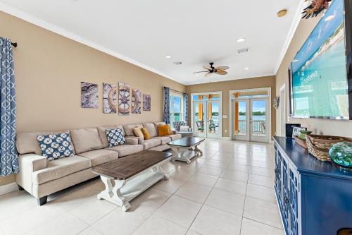a living room with a couch and a tv at Eagle's Nest in Gulf Shores