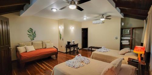 a living room with two beds and a couch at Selva Verde Lodge in Sarapiquí