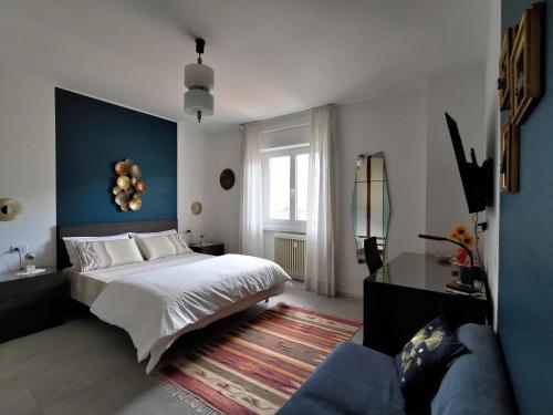 a bedroom with a bed and a blue wall at Design apartment n. 41 in Trento