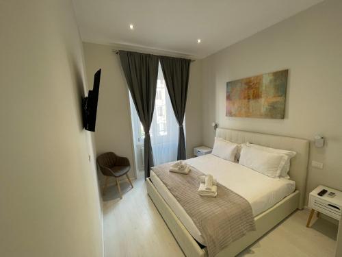 a bedroom with a bed with a tray on it at Quintus Luxury Suites in Rome