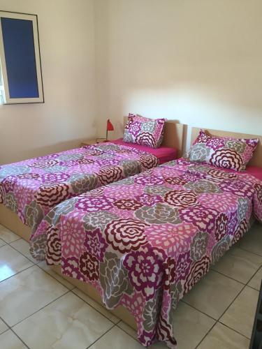 two beds sitting next to each other in a room at Residence Nadia in Tabarka