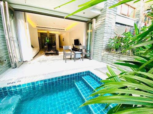 a swimming pool in front of a house at Beachfront 2br home with private plunge pool on stunning Naithon beach 3 in Nai Thon Beach