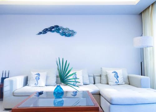a living room with a white couch and a table at Beachfront 2br home with private plunge pool on stunning Naithon beach 3 in Nai Thon Beach