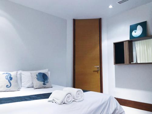 a hotel room with a bed with towels on it at Beachfront 2br home with private plunge pool on stunning Naithon beach 3 in Nai Thon Beach