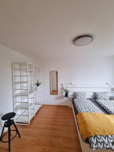 a bedroom with a bed and a white book shelf at -NEW-Rosetta Apartment in Piešťany
