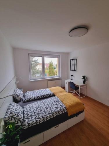 a bedroom with a large bed and a window at -NEW-Rosetta Apartment in Piešťany