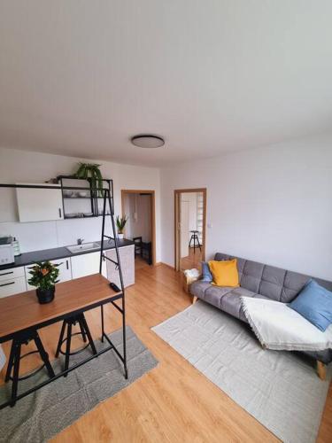 a living room with a couch and a table at -NEW-Rosetta Apartment in Piešťany