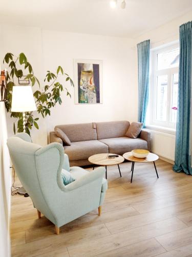 a living room with a couch and two tables at Wertschätzer II - Unter der Wehme in Detmold