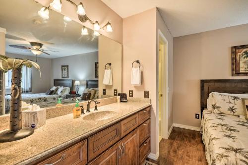 a bathroom with a sink and a bed at Lakefront Branson Condo, Near Silver Dollar City! in Branson