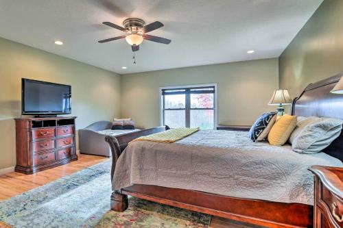 a bedroom with a bed and a flat screen tv at Cozy Home with Patio, 2 Mi to Dale Hollow Lake! in Frogue