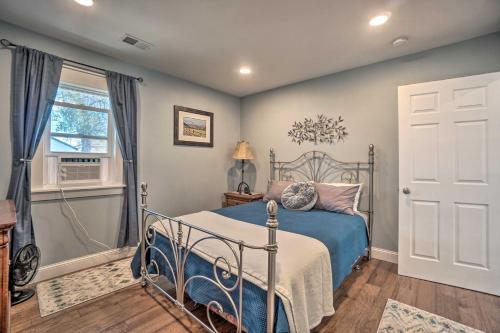 a bedroom with a bed and a window and a door at Charming Cheyenne Home about 1 Mi to Downtown! in Cheyenne