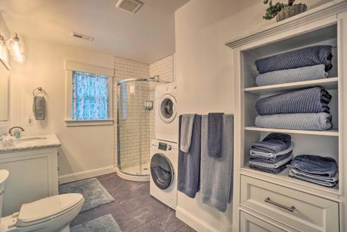 a bathroom with a shower and a toilet and towels at Charming Cheyenne Home about 1 Mi to Downtown! in Cheyenne