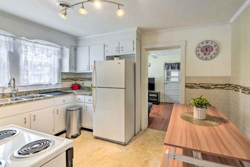 a kitchen with a white refrigerator and a wooden table at Charming Beaufort Getaway Walk to the Waterfront! in Beaufort