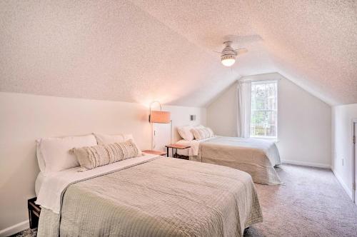 a bedroom with two beds and a window at Cozy Home with Yard about 9 Mi to Dtwn Charleston! in Charleston