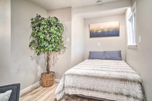 a bedroom with a bed and a potted plant at Adorable Studio Cottage Walkable to Town! in Grants Pass