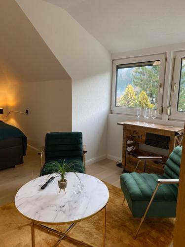 uma sala de estar com uma mesa e cadeiras e um piano em Villa-Stern em Keutschach am See