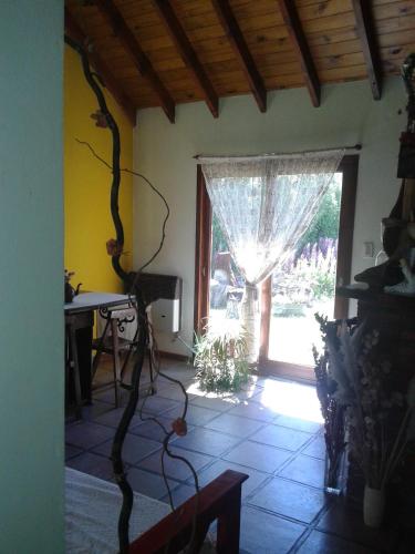 a living room with a window and a table at Kiritina´s House Homestay in El Calafate