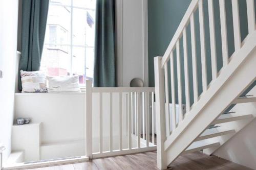 a white staircase in a room with a window at 1001 Nights Boutique Lofts in Haarlem