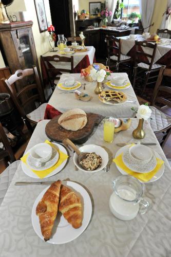 a table with plates of food and bread on it at Hotel Etoile De Neige in Valtournenche