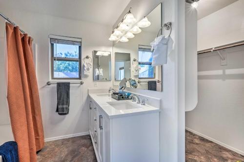 a bathroom with a sink and a mirror at Avondale Home with Pool, 5 Mi to State Farm Stadium! in Avondale