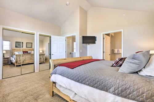 a bedroom with a bed and a television and a room at Spacious Fraser Condo about 6 Mi to Winter Park! in Fraser