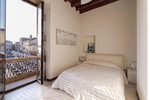 a bedroom with a bed and a large window at Arona Prestige Apartments in Arona