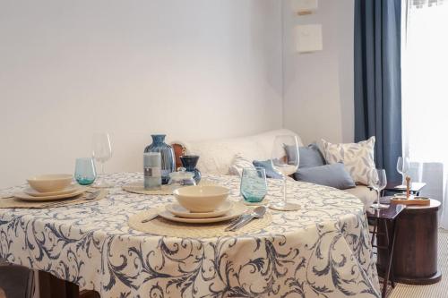 a table with plates and wine glasses on it at La casina de cori in Luarca