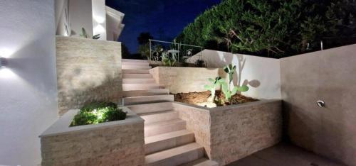 a set of stairs with potted plants on them at Villa Taliala in Alcamo Marina