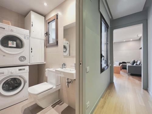 a bathroom with a washing machine and a washer and dryer at Stay U-nique Apartments Rambla Catalunya II in Barcelona