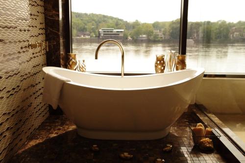 a bath tub in a bathroom with a large window at Lambertville Station Inn in Lambertville