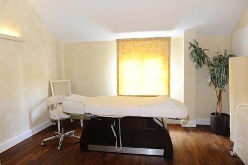 a hospital room with a bed and a window at HELIOPARK Bad Hotel Zum Hirsch in Baden-Baden