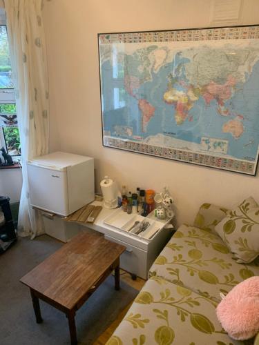 a room with a bed and a table and a map on the wall at 97 Granville road in Dublin