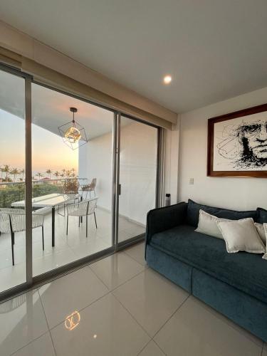 a living room with a couch and a dining room at AriaOcean#410 in Nuevo Vallarta