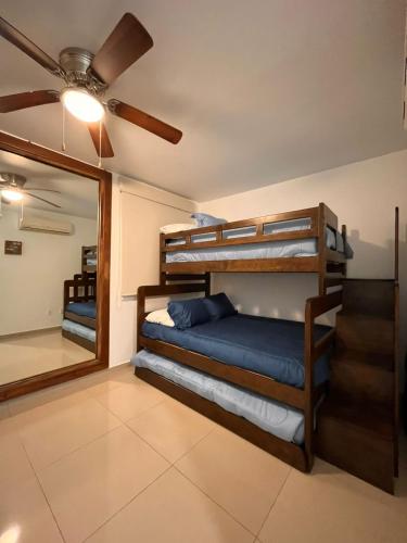 a bedroom with bunk beds and a ceiling fan at AriaOcean#410 in Nuevo Vallarta