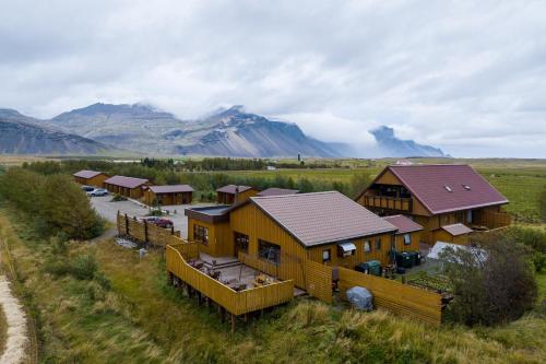 an aerial view of a lodge with mountains in the background at Árnanes Country Hotel in Höfn