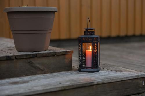 a candle sitting on a table next to a pot at Árnanes Country Hotel in Höfn