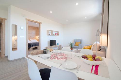 a kitchen and living room with a table and chairs at La Asomada de Vidular in Bárcena de Cicero