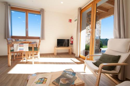 a living room with a couch and a table at La Asomada de Vidular in Bárcena de Cicero