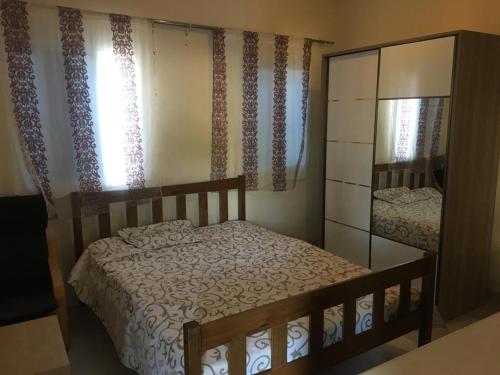 a bedroom with a bed and a dresser and a mirror at The Rock Garden Apartments in Amdalai