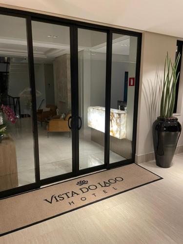 a sliding glass door in a room with a living room at Vista do Lago Hotel in Capitólio