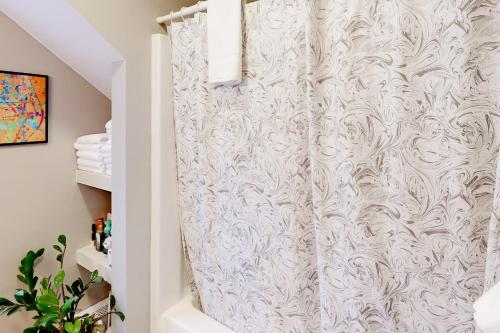 a shower curtain in a bathroom with a white shower at Londonderry Retreat in Londonderry
