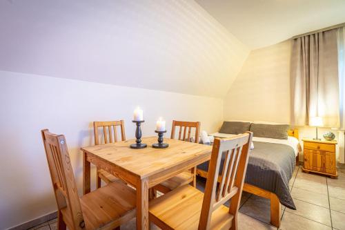 a dining room with a table and a bed at Liberta INN - Pokoje Gościnne in Zakopane