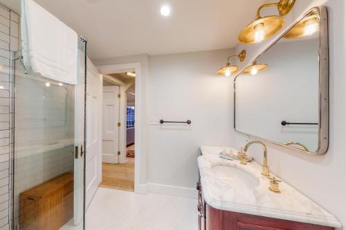 a bathroom with a sink and a mirror at Modern Harbor Retreat in Rockland