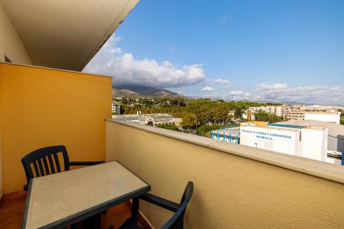 a table and chair on a balcony with a view at Senator Marbella in Marbella