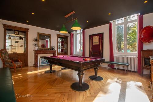a living room with a pool table in the middle at La VILLA ILIXON in Luchon