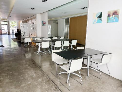 a group of tables and white chairs in a room at Park Soho Recoleta in Buenos Aires