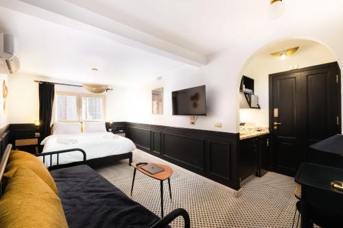 a hotel room with a bed and a tv at The Bold Signature 1BDR Studio Cairo's Downtown 21B in Cairo