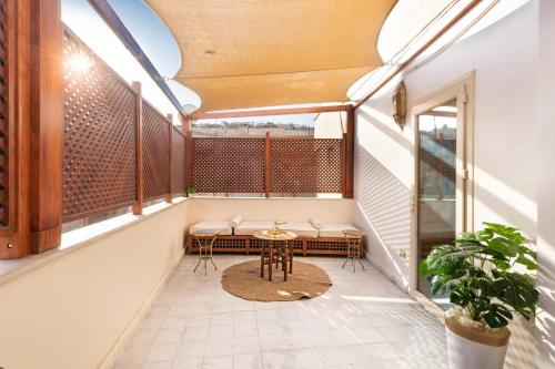 a balcony with a table and chairs on it at Marrakesh 1BDR w Jacuzzi Terrace Downtown Cairo in Cairo