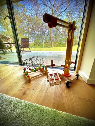 a childs toy on the floor in front of a window at 100m2 Fewo im Haus am See mit Garten bei Potsdam in Schwielowsee