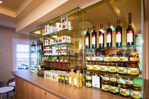 a store with a display case filled with bottles of wine at Hotel Allmer in Bad Gleichenberg